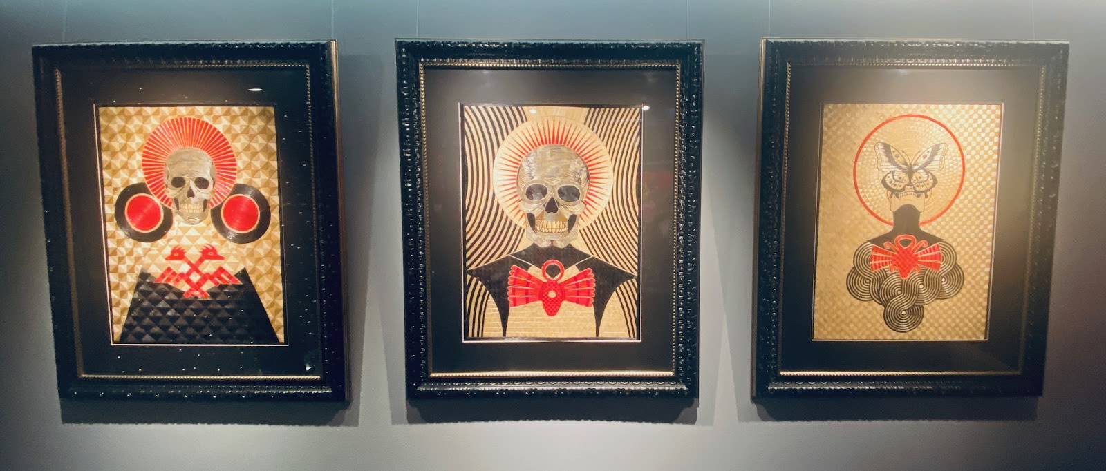 a trio of skull artworks