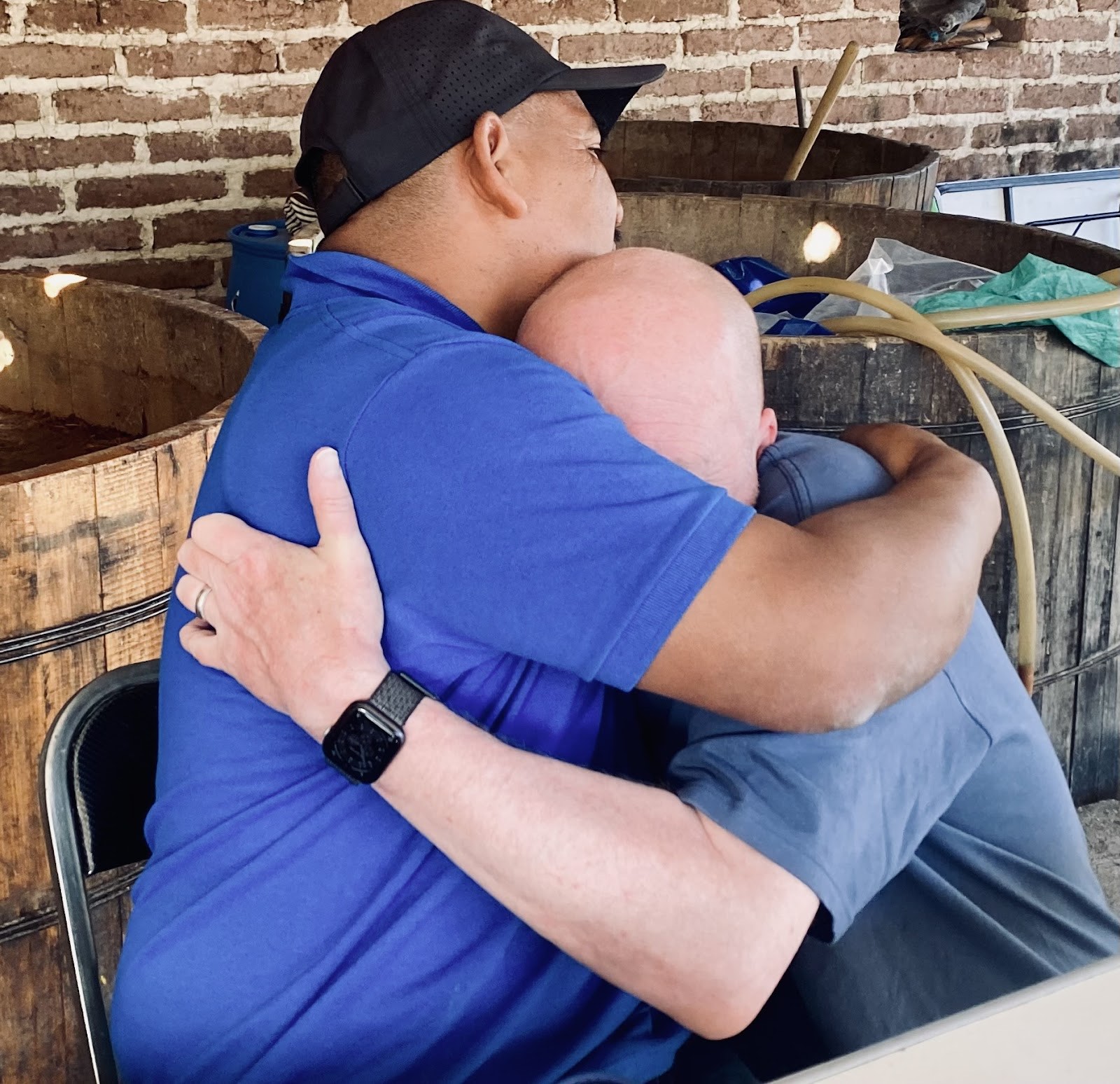 two men by the fermentation tanks