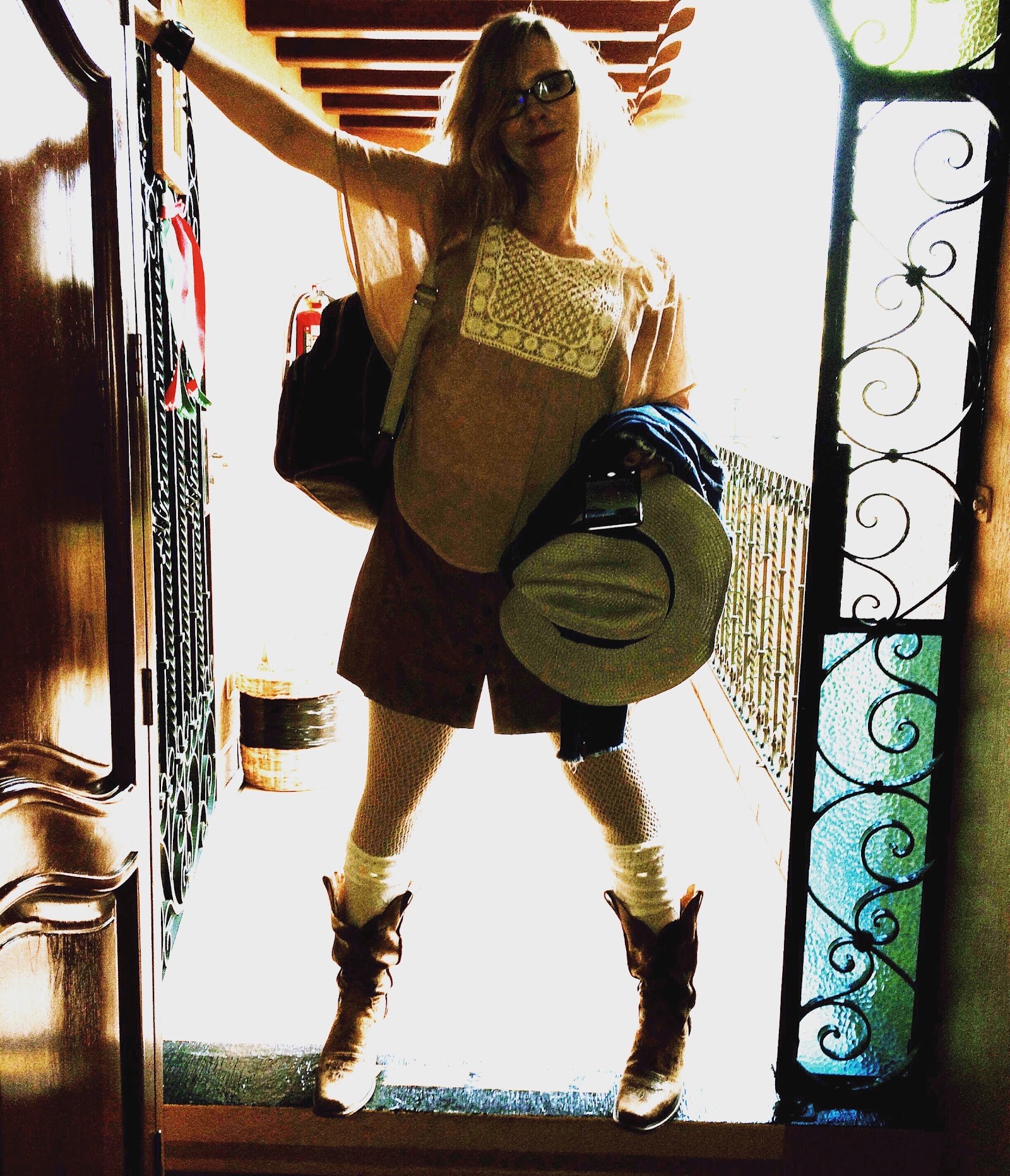 in cowboy boots at the doorway